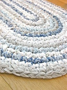 a blue and white rug is on the floor in front of a wooden table top