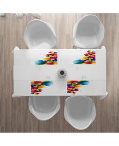 two white urinals sitting on top of a wooden floor