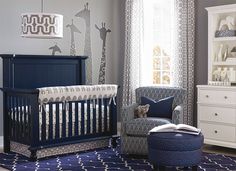 a baby's room with a blue crib, white dresser and gray curtains