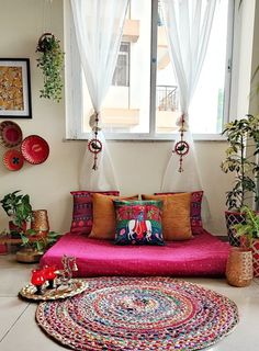 a living room filled with lots of colorful furniture and decor on top of a rug