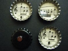 four bottle caps with musical notes on them