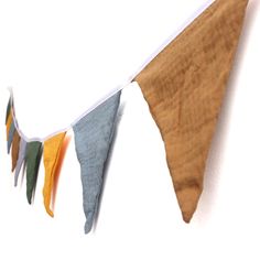 an orange, yellow and green pennant hanging from a wall