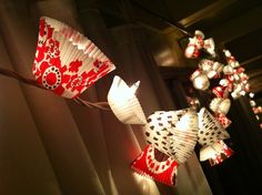 red and white paper fan lights hanging from the ceiling