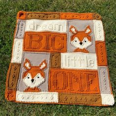 a crocheted blanket with an image of a fox on it