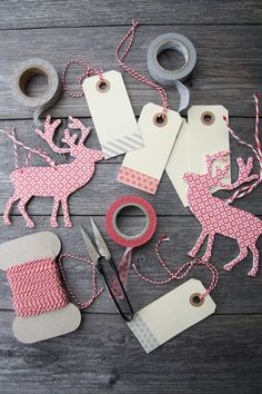 sewing supplies are laid out on a wooden table with scissors, tape and other items