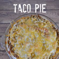 baked layered taco pie in a glass dish with text overlay that reads baked layered taco pie