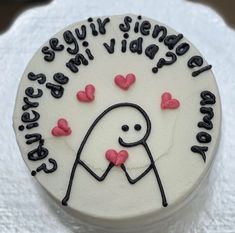 a white cake with black writing and hearts on it