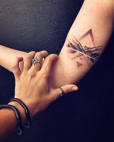 two hands holding each other with an instagram logo on the left side of their arm