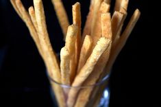 a glass filled with french fries on top of a table