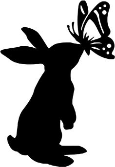 a silhouette of a rabbit with a butterfly on its head