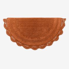 an orange placemat with crocheted edges