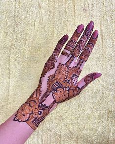 a woman's hand with hennap on it, showing the intricate design