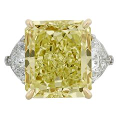 This monumental 20.28-carat natural fancy yellow diamond ranks among the rarest and most coveted of all gemstones. The rare stone is certified by the Gemological Institute of America (GIA) as natural fancy yellow, and its exceptional hue displays even color distribution that is enhanced by its modified brilliant cut. It also earns a VVS2 clarity grade, meaning its natural color is virtually unmarred to the naked eye - a rare achievement for a stone of this size. Colored diamonds are among the sc Rings Fancy, Glitter Rocks, Fancy Yellow Diamond Ring, Radiant Cut Diamond Ring, White Engagement Ring, Jewelry Fancy, Yellow Diamond Ring, Yellow Ring, Oval Diamond Ring