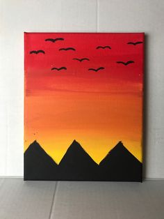 an acrylic painting of birds flying in the sky over pyramids at sunset