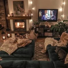 a living room filled with furniture and a flat screen tv mounted on the wall next to a fire place