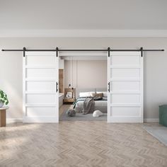 a bedroom with two sliding doors and a bed in the corner, next to a wooden floor