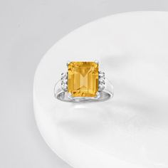 Ross-Simons - 5.30ct Citrine, .20ct t. w. White Topaz Ring in Silver. Size 8. Like a warm ray of sunshine, this 5.30 carat emerald-cut citrine ring beams radiantly. Set atop a band of polished sterling silver, trios of .20 ct. t. w. white topaz rounds work to accentuate the shine of the entire design. 1/2" wide. White topaz and citrine ring. Citrine birthstones are the perfect gift for November birthdays. Citrine Drop Earrings, Citrine Birthstone, Citrine Earrings Studs, Three Strand Necklace, Emerald Earrings Drop, Topaz Color, Citrine Ring, Pearl Hoop Earrings, Topaz Ring