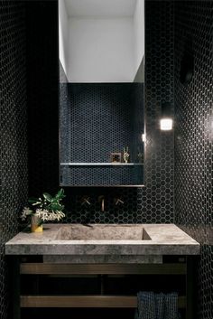 a bathroom sink sitting under a mirror next to a wall mounted faucet with lights on it