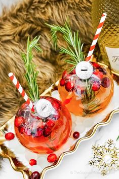 two glasses filled with liquid sitting on top of a tray