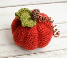 a knitted pumpkin sitting on top of a white table