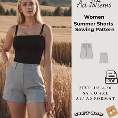 a woman standing in front of a wheat field with her hands on her hips and wearing shorts