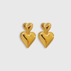 Elevate your style with the stunning Heart Statement Earrings from Biella Vintage. Crafted with exquisite attention to detail, these earrings feature a luxurious gold-plated finish that adds a touch of elegance to any outfit. The bold heart design makes a chic statement, perfect for both day and night wear. Whether you're dressing up for a special occasion or adding a glamorous touch to your everyday look, these earrings are the perfect accessory. Let your style shine with Biella Vintage. Material: High-quality 18k gold-plated Design: Bold heart shape Style: Statement, versatile Occasions: Perfect for any event or casual wear Enhance your jewelry collection with a piece that embodies timeless elegance and modern charm. Elegant Gold Plated Heart Pendant Earrings, Elegant Gold Plated Earrings For Valentine's Day, Elegant Gold Plated Heart Earrings For Party, Gold Heart Pendant Earrings For Party, Gold Plated Earrings For Valentine's Day Formal, Gold Plated Earrings For Valentine's Day Formal Occasions, Chic Heart Charm Earrings For Valentine's Day, Yellow Gold Heart Earrings For Valentine's Day Party, Yellow Gold Heart Earrings For Party