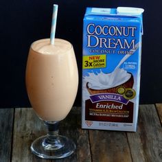 a drink next to a carton of milk and a carton of coconut dream