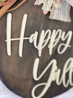 a wooden sign that says happy girl with flowers on the front and back of it