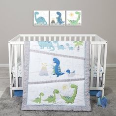 a baby crib bedding set with blue and green dinosaurs