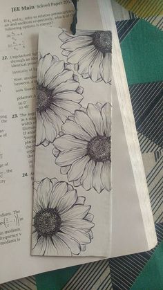 some paper with flowers on it next to a piece of paper that has been folded