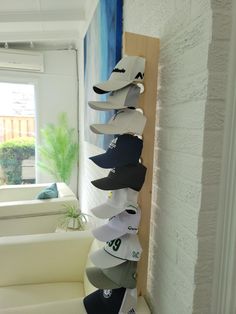 a stack of hats hanging from the side of a wall