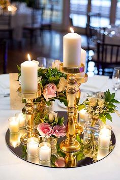 a table with candles and flowers on it