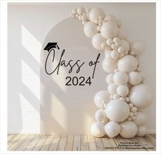 a graduation balloon arch with the words class of 2021 in black and white on it