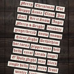 several red and white stickers on a wooden surface with the words merry christmas written across them