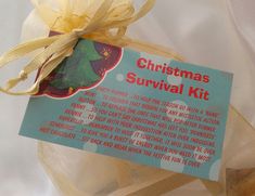 a christmas survival kit is wrapped in clear plastic and tied with a yellow ribbon around it