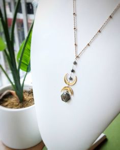 This crystal necklace is handmade with a hexagonal  labradorite briolette, two 18k gold plated stainless steel crescent moons, larkivite beads, and hypoallergenic gold plated stainless steel satellite chain.  Necklace length: 18 inches + 2.5 inch extender Pendant height: 2.5 inches Benefits of Labradorite: ♡ Imparts strength and perseverance  ♡ Balances and protects ♡ strengthens intuition and discernment Benefits of Larkivite: ♡ Subtle cleansing properties ♡ Connects one to the earth ♡ Stimulat Labradorite Moon Charm Jewelry For Healing, Gold Labradorite Jewelry With Moon Charm, Gold Jewelry With Labradorite Moon Charm, Gold Jewelry With Moon Charm And Labradorite, Celestial Moon Phase Necklace In Labradorite, Labradorite Necklace With Moon Charm For Healing, Labradorite Moon Shaped Necklace With Moon Charm, Labradorite Moon Charm Necklace, Brass Jewellery