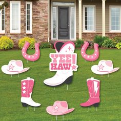 pink cowboy boots and stars yard decorations in front of a house with the words i do it