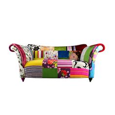 a patchwork couch with colorful pillows on it's back and arms, sitting in front of a white background