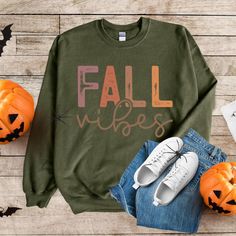 Embrace the essence of autumn with our Fall Vibes sweater, designed to capture the vibrant hues of the season. Featuring a stunning array of fall colors, this shirt is perfect for cozy gatherings, crisp walks, or simply celebrating the beauty of fall. Made from soft, breathable fabric, it ensures comfort while showcasing your love for all things autumn. Get ready to turn heads and spread those fall vibes wherever you go! Product features - Medium-heavy fabric blend of 50% cotton and 50% polyeste Green Long Sleeve Sweatshirt For Fall, Trendy Cozy Fit Sweatshirt For Fall, Green Cotton Sweater For Fall, Cozy Fall Sweater With Graphic Print, Graphic Print Cozy Fit Sweatshirt For Fall, Cozy Fit Graphic Sweatshirt For Fall, Cozy Fit Fall Sweatshirt, Cozy Fit Graphic Print Sweatshirt For Fall, Cozy Fit Crew Neck Sweatshirt For Fall