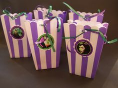 purple and white striped paper bags with green ribbons tied around the handles, featuring an image of a woman's face