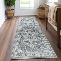 a large rug is on the floor in front of a door with a potted plant