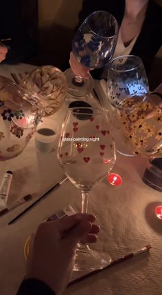 people are sitting at a table with wine glasses