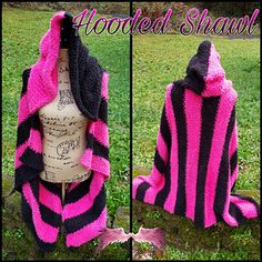 a pink and black knitted shawl sitting on top of a mannequin