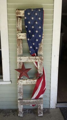 an old ladder is painted red, white and blue with the american flag on it