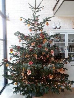 a decorated christmas tree in the corner of a room