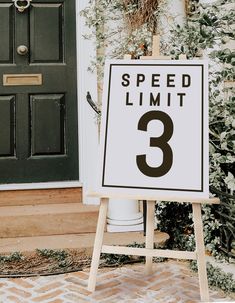 a speed limit sign sitting in front of a door