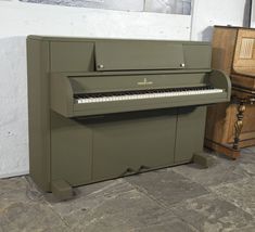 a green piano sitting on top of a stone floor