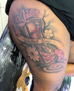 a woman's thigh with tattoos on it that says tattoo time and some flowers