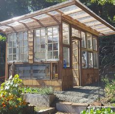 a small wooden building with lots of windows