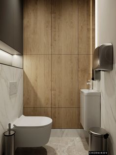 a modern bathroom with wood paneling and white fixtures, including toilet paper dispenser